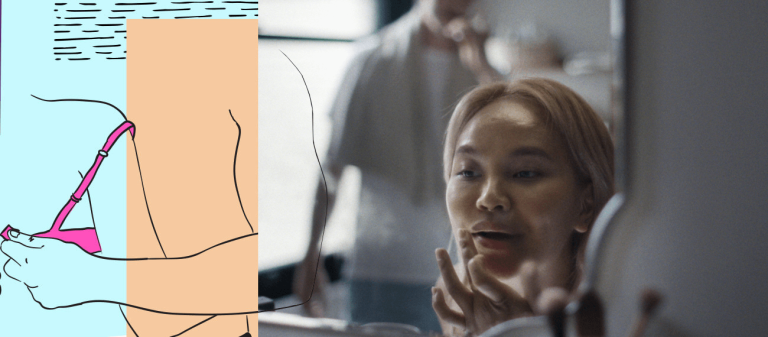 woman looking at herself in the mirror